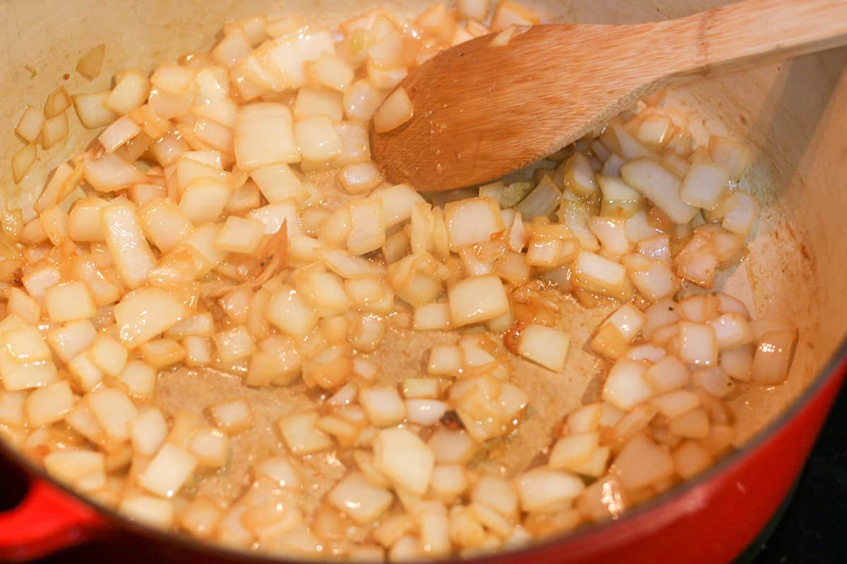 Onions being sauteed in a Dutch Oven. 