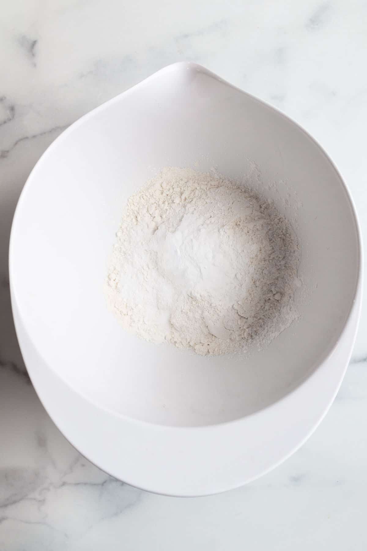 A batter bowl with flour, salt, baking soda and baking powder.