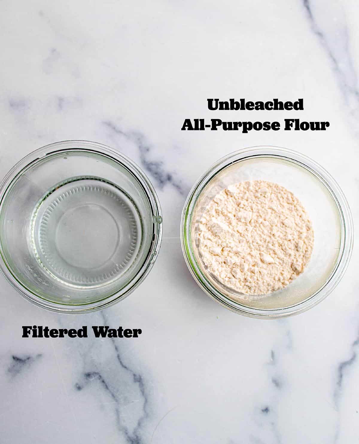 Two glass jars, one with all-purpose flour and the other with filtered water.