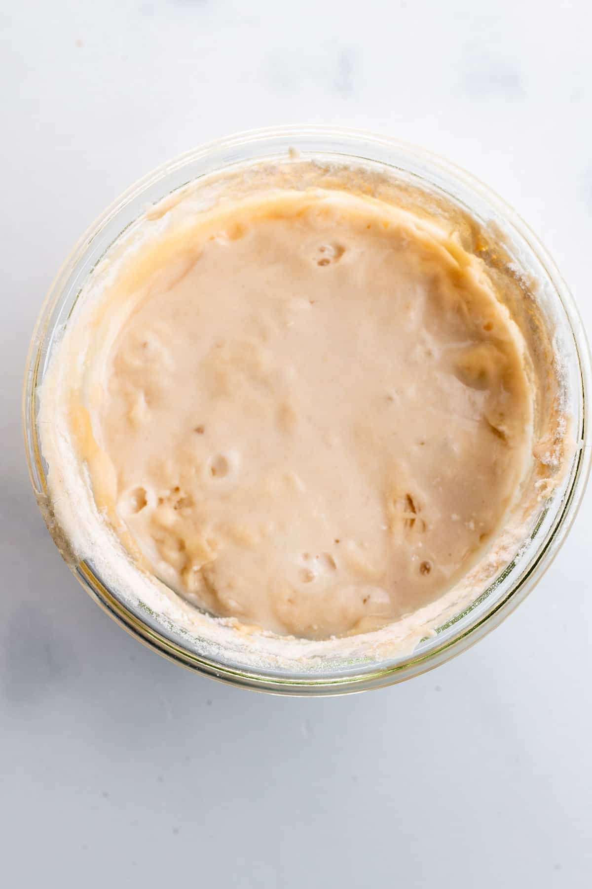 Day 7 of a sourdough starter in a glass jar.