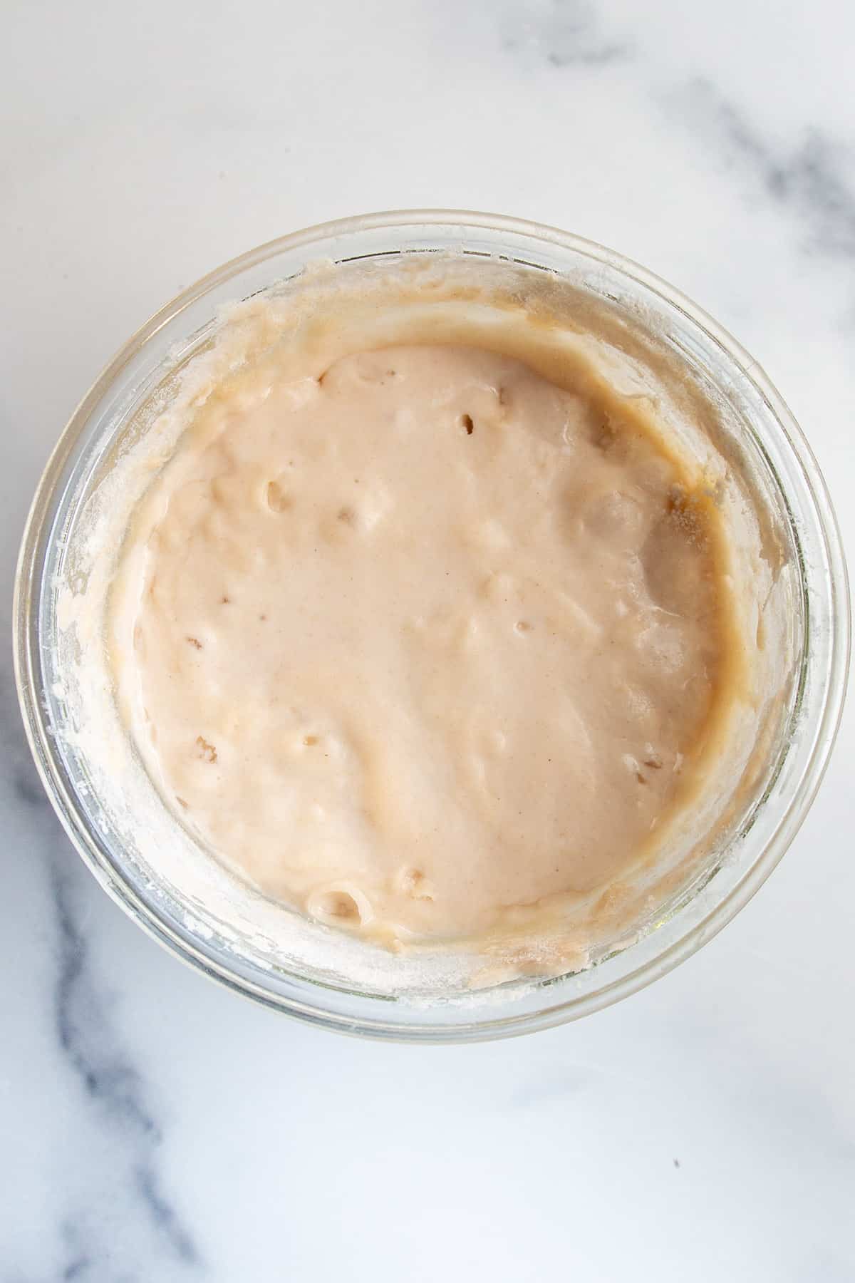 A sourdough starter in a jar on day 4.