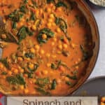 A red braiser with a chickpea curry mix with text that says spinach and chickpea curry.