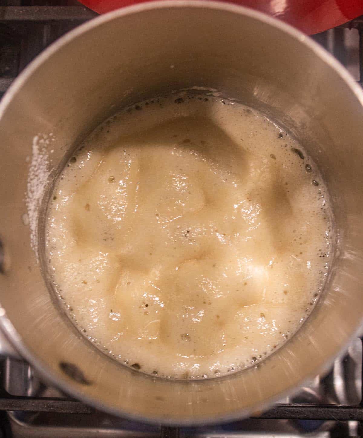 A mix of butter and flour bubbling to start a roux. 