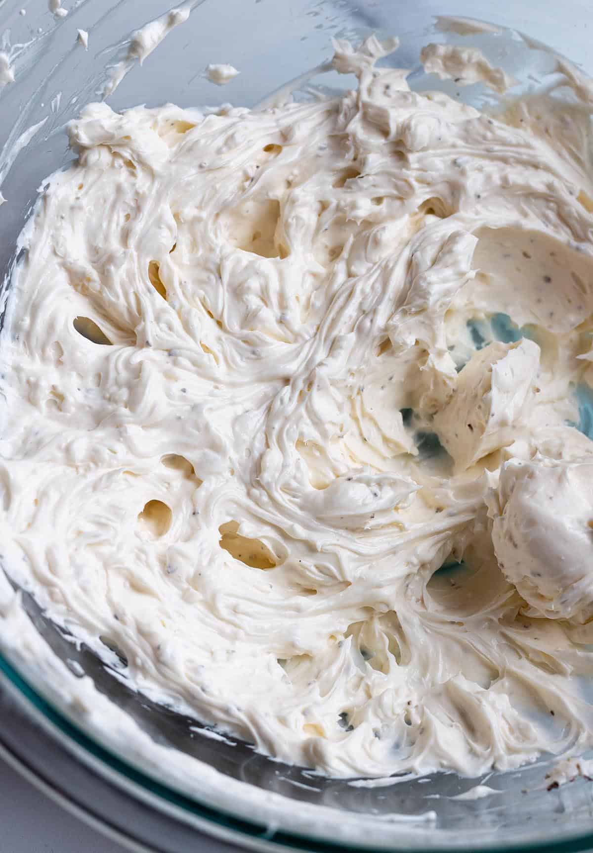 A bowl with a cream cheese spread. 