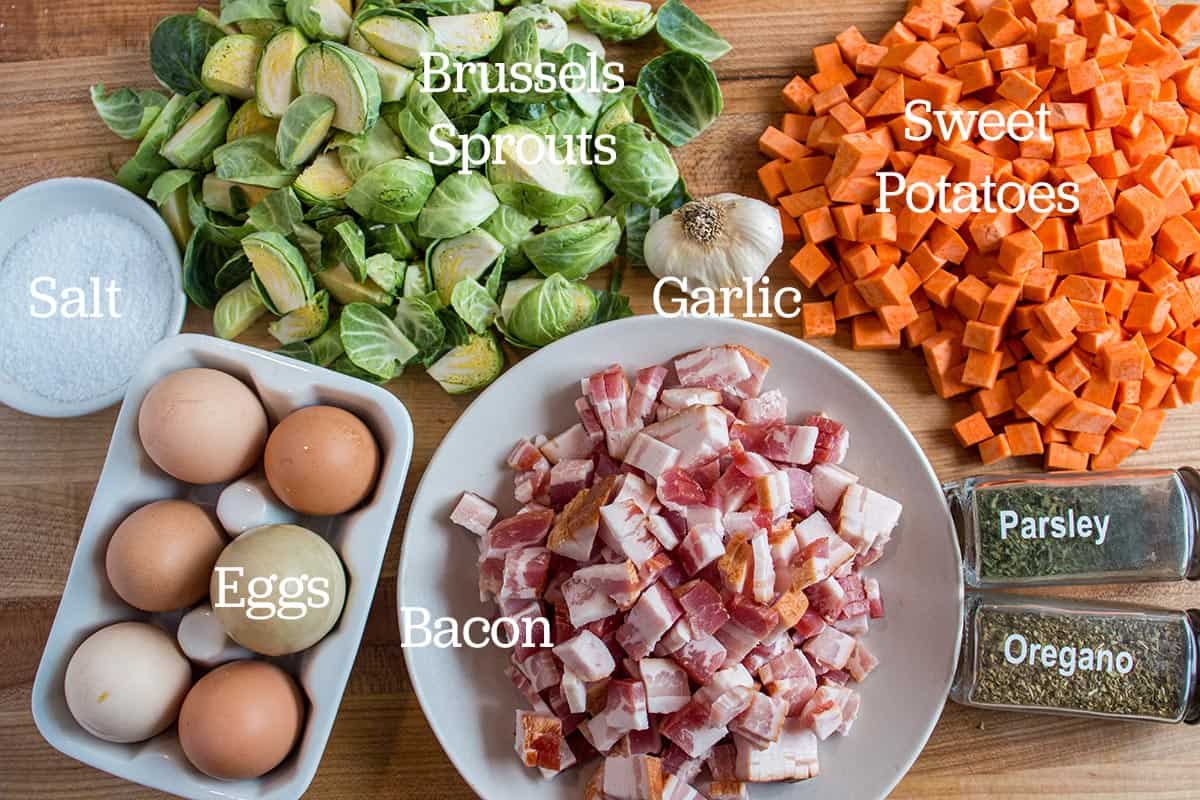 Chopped up brussels sprouts, diced sweet potatoes, diced raw bacon, whole garlic, fresh eggs, parsley, oregano, and salt. 