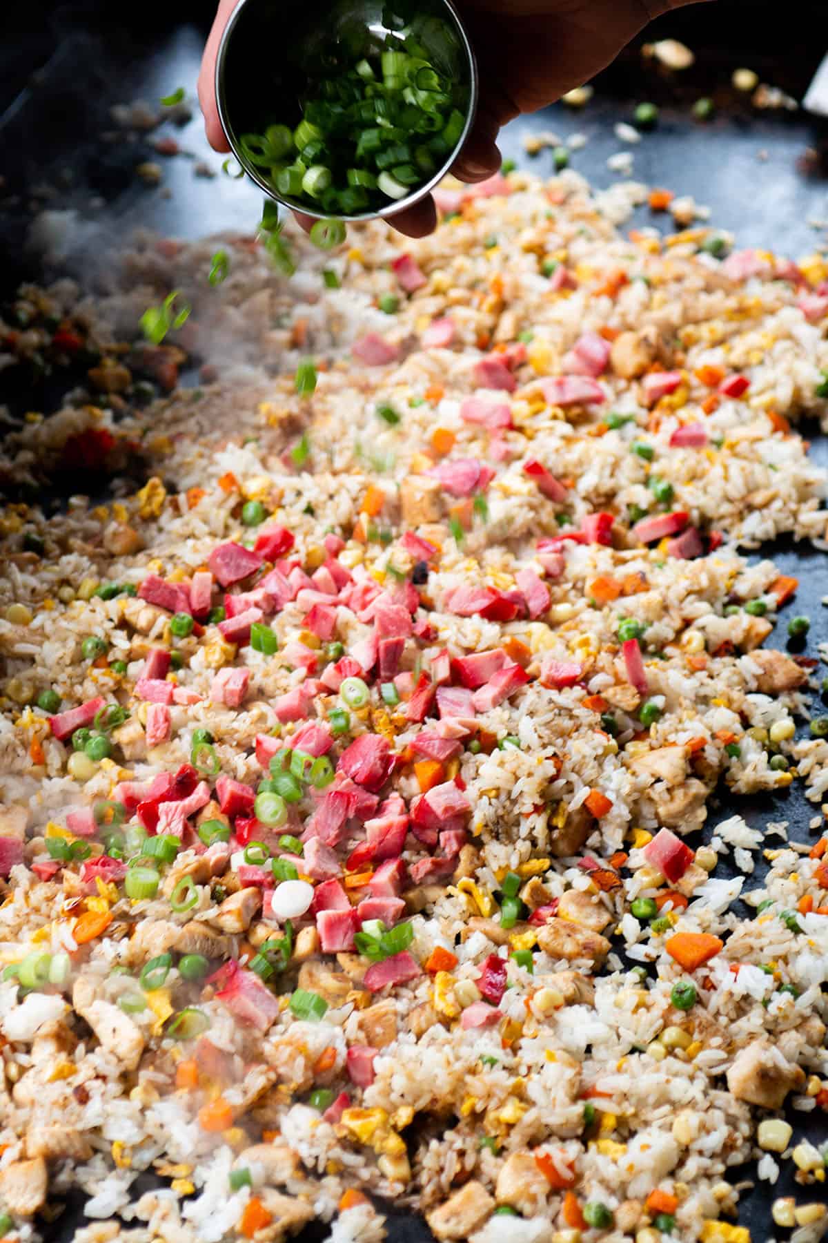 Koren BBQ Pork and green onion being added to the fried rice mix. 