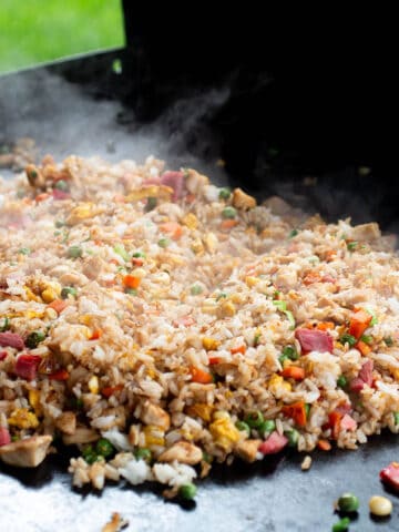 A Blackstone cook top with a pile of homemade fried rice.