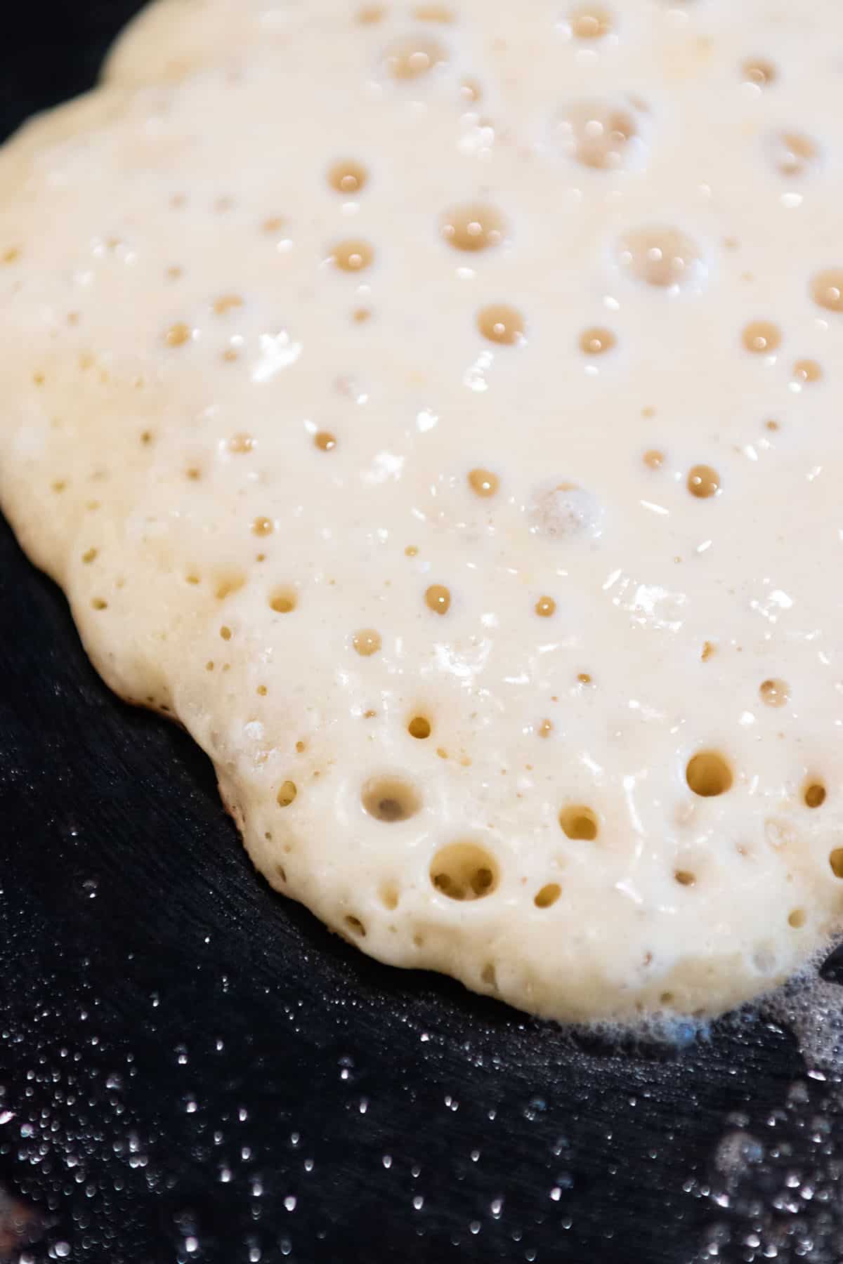 A sourdough pancake with lots of bubbles. 