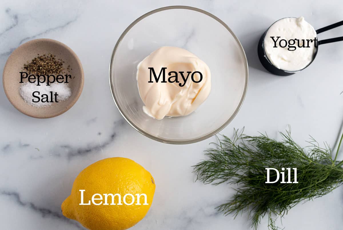 Bowl with mayo, measuring cup with yogurt, lemon, dill, salt and pepper.