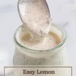 Small jar with a spoon scooping out a white sauce.