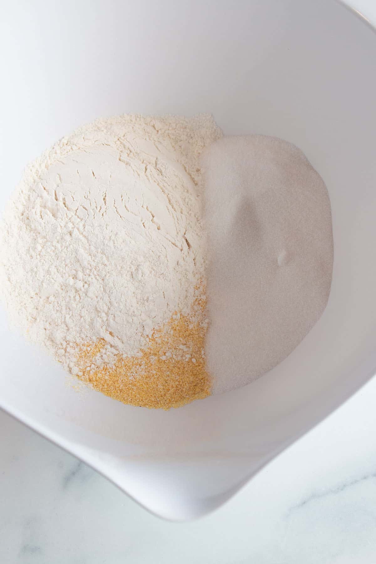 Mixing bowl with flour, corn meal, sugar, salt and baking powder.