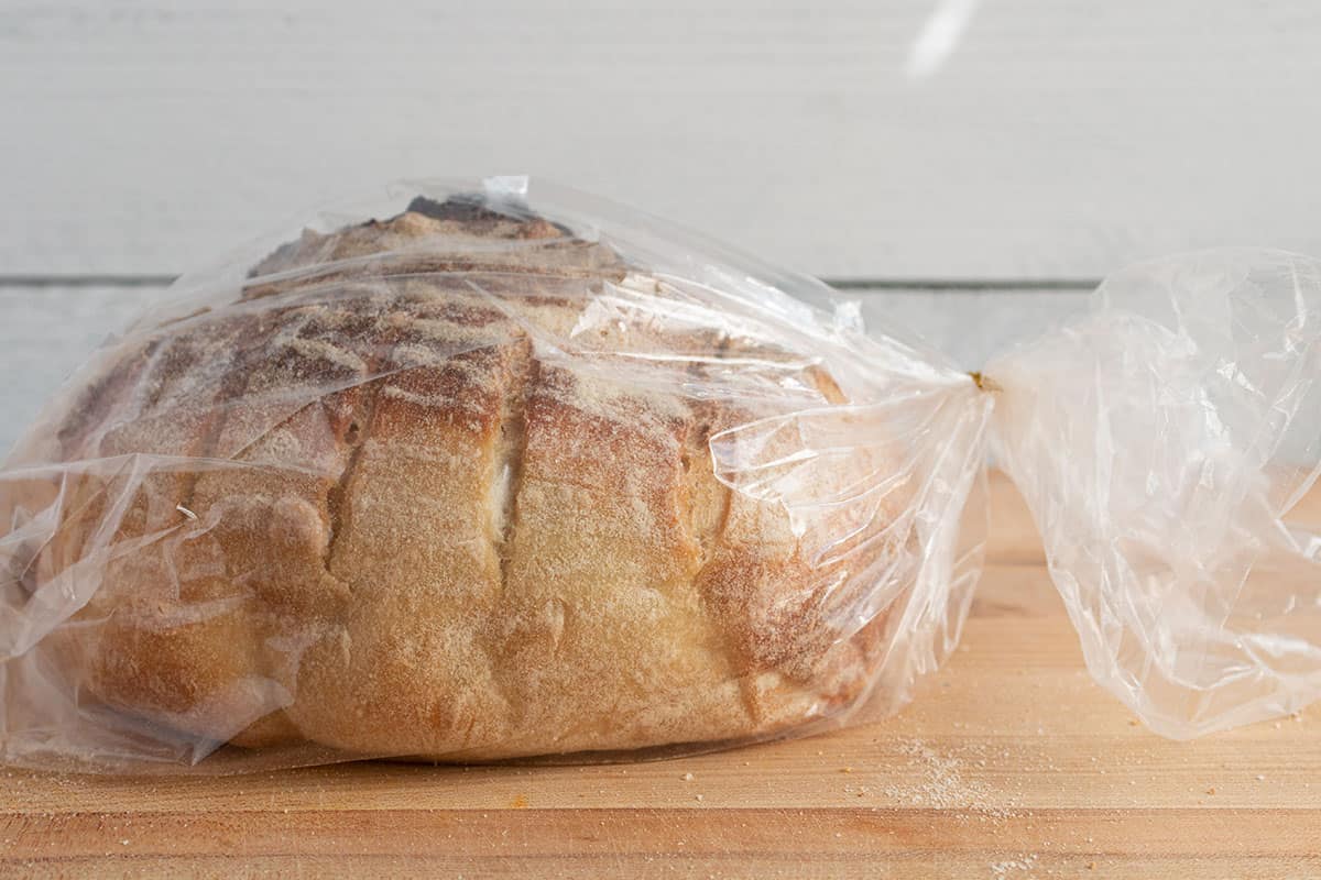 A loaf of sourdough in a plastic bag with a twist tie.