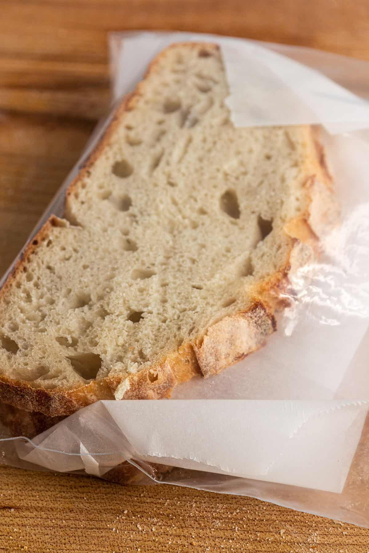 Slices of sourdough bread with parchment paper in between.