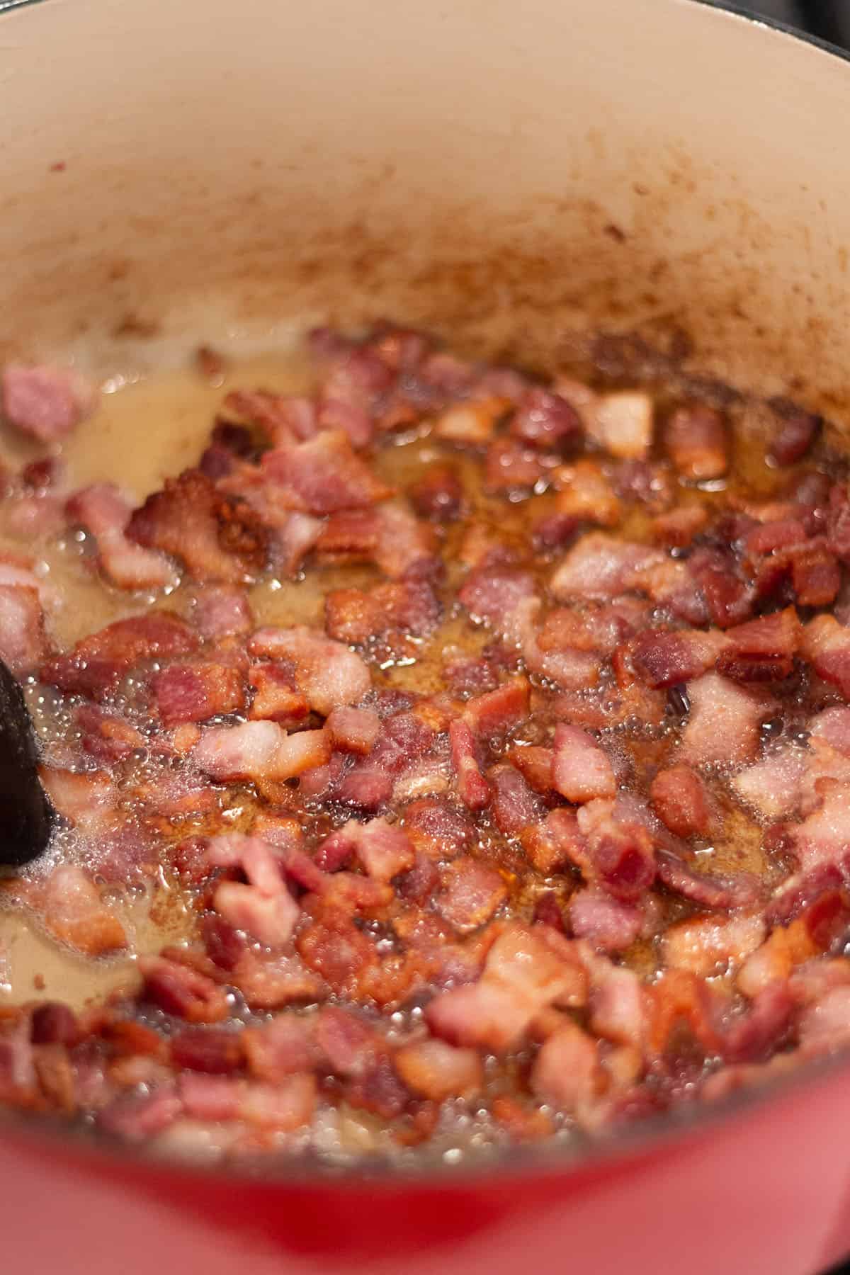 Large Dutch Oven pot with bacon simmering. 