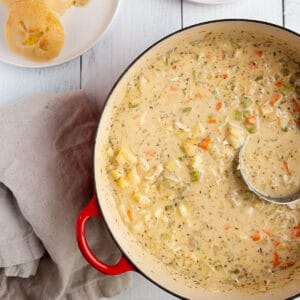 A large dutch oven pot with a creamy clam chowder.