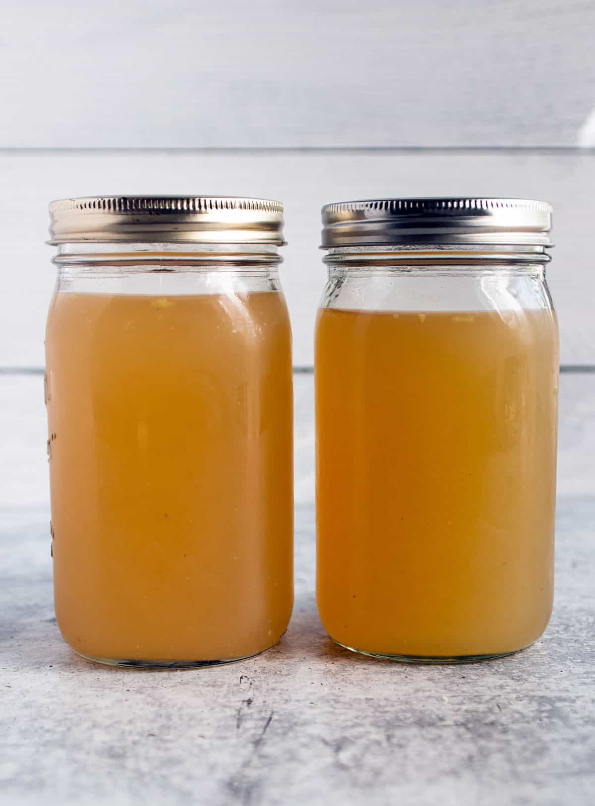 Two large mason jars with a homemade turkey broth. 