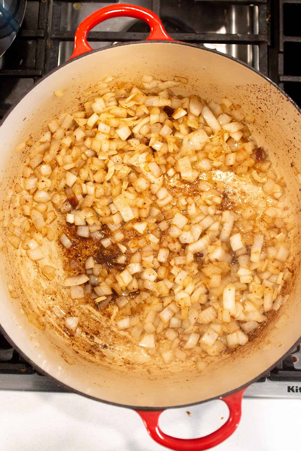 A large Dutch Oven with onions sautéing. 