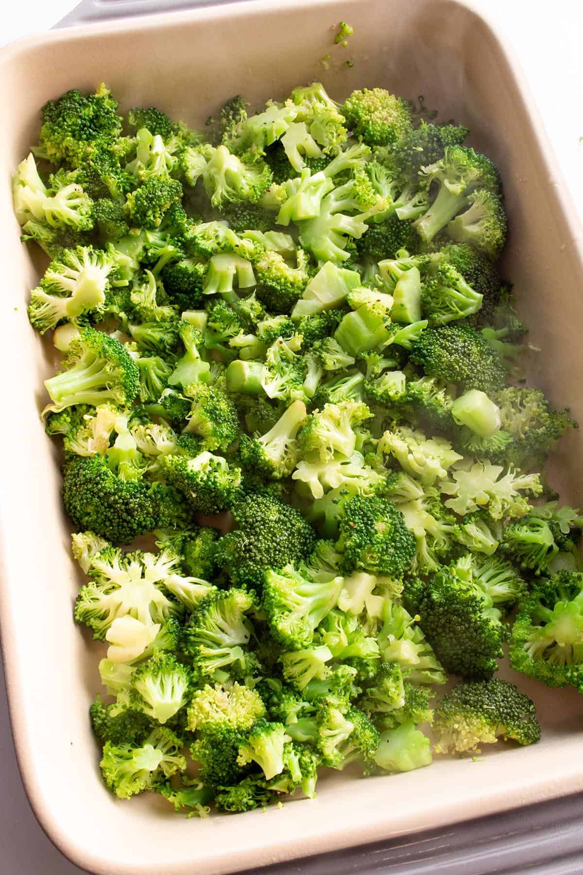 Steamed broccoli laid out in a baking dish. 