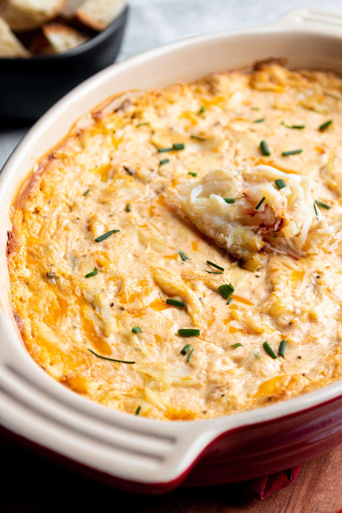 Oval baking dish with hot crab dip. 