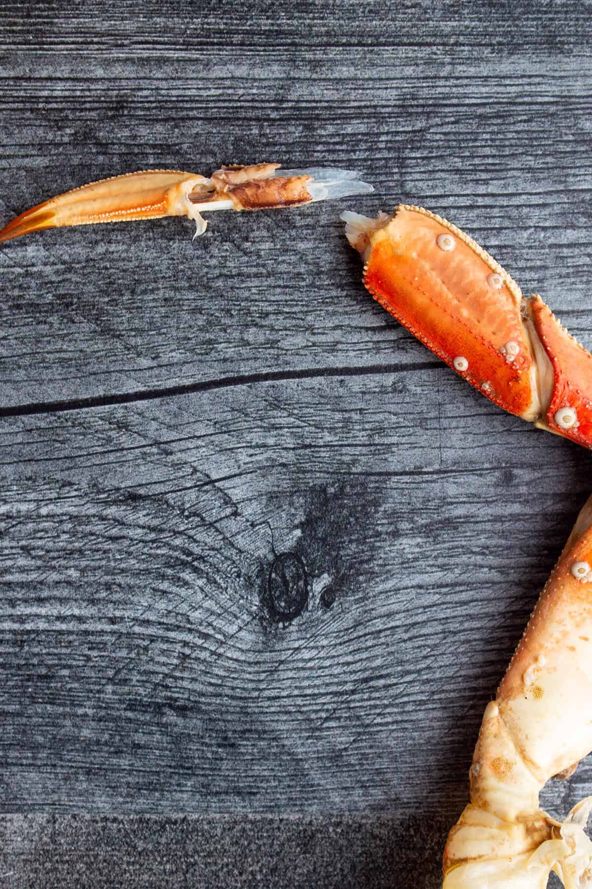 The tip of a crab leg being removed.