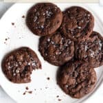 A plate with chocolate cookies topped with Malden salt.