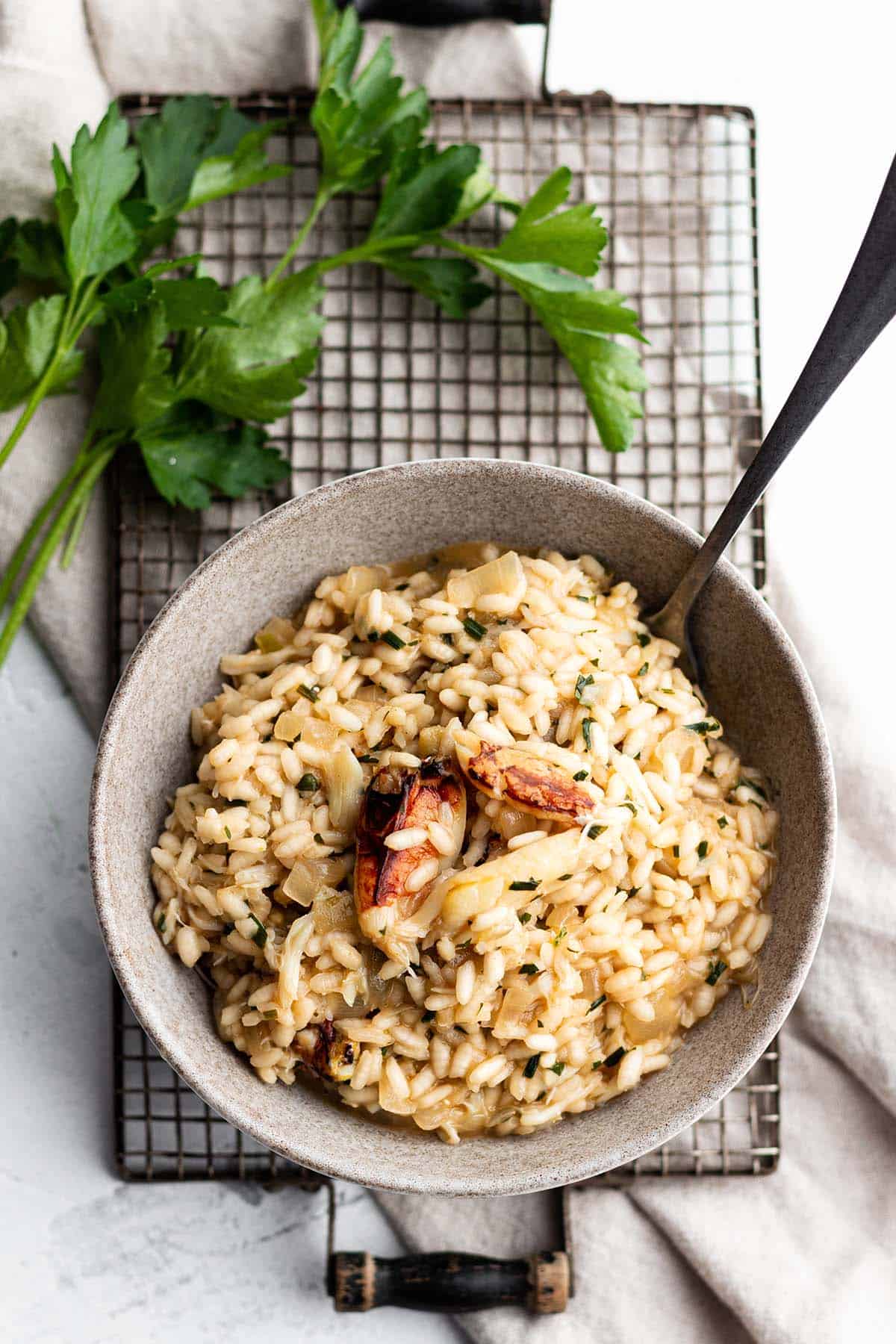 A small bowl with a risotto rice and lumps of crab meat on top. 