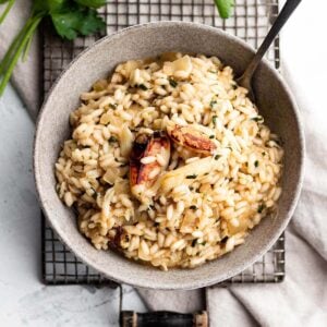 A small bowl full of risotto topped with fresh crab meat.