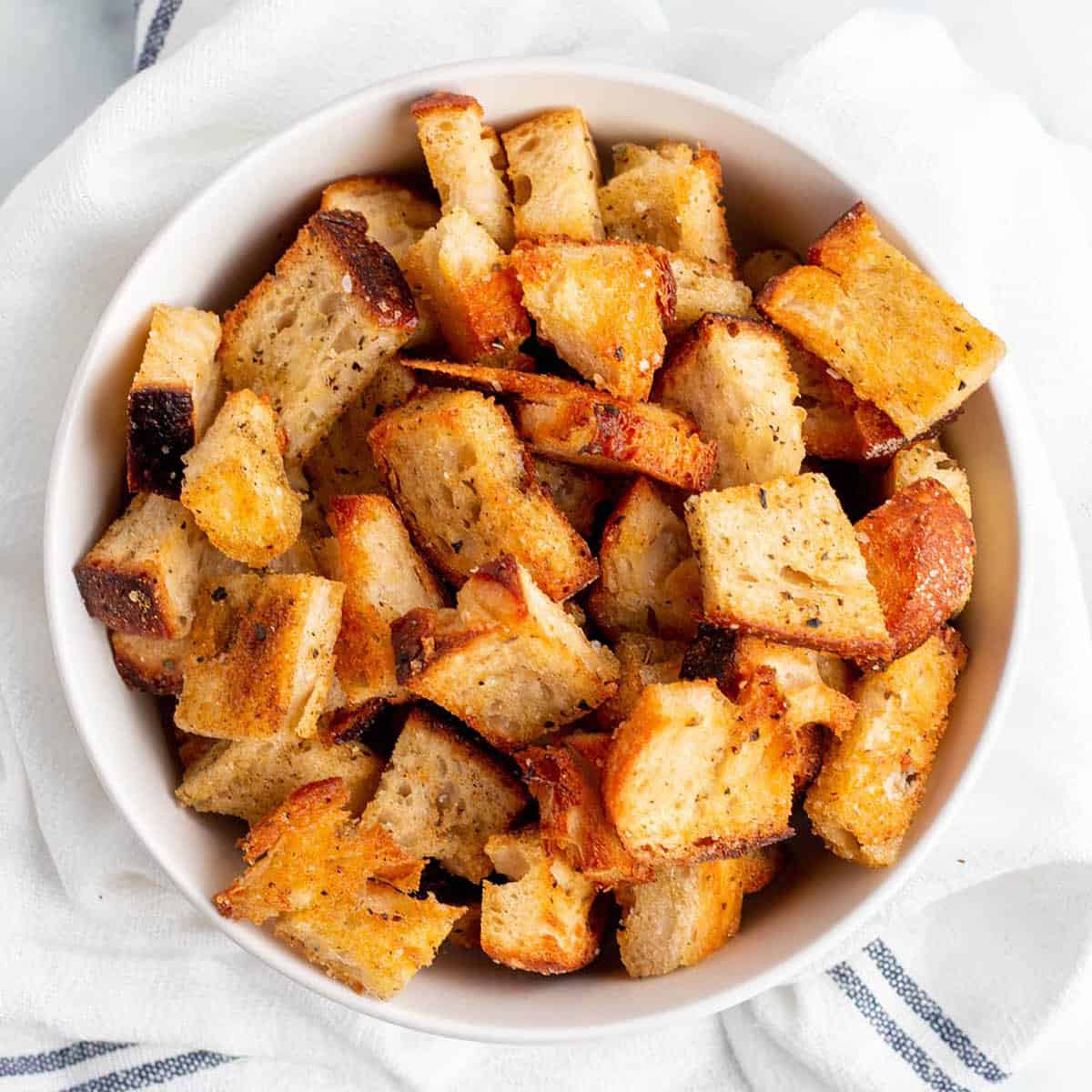 A bowl full of homemade croutons.