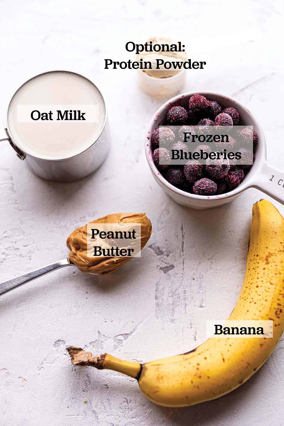 Banana, frozen blueberries, peanut butter, oat milk and protein powder.