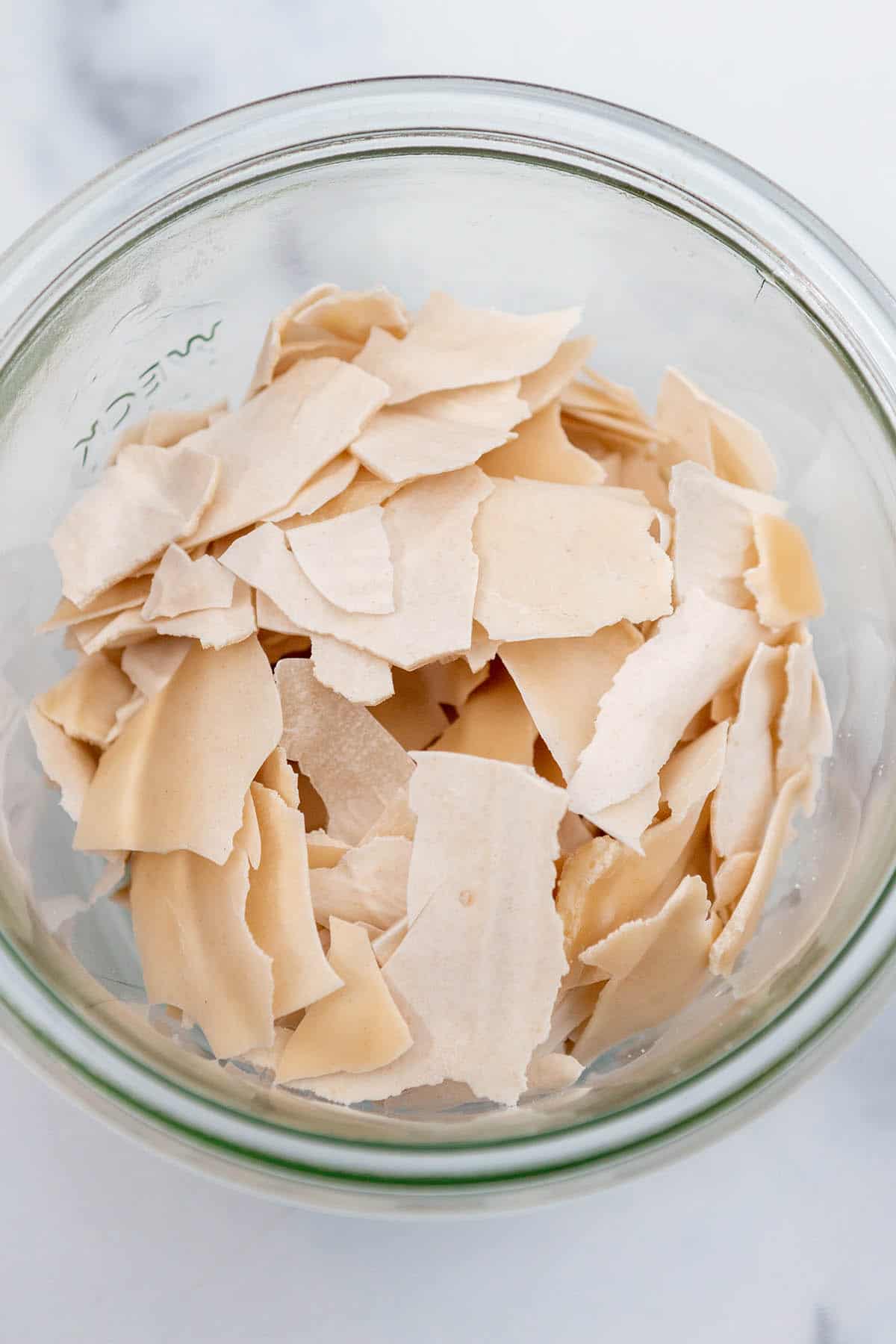 A jar with dried sourdough starter chips. 