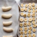 Two baking sheets with diced up bananas.