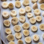 Parchment paper with sliced up bananas.