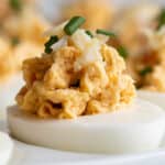 A deviled egg topped with fresh Dungeness crab and chive.