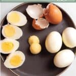A plate with full hard boiled eggs, some cut in half and others with the yolks removed with text that says perfect hard boiled eggs.