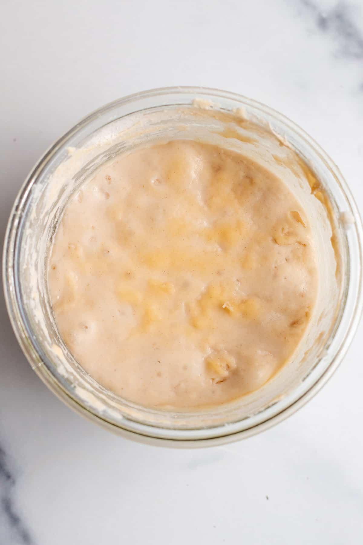 Day 6 of a sourdough starter in a glass jar.