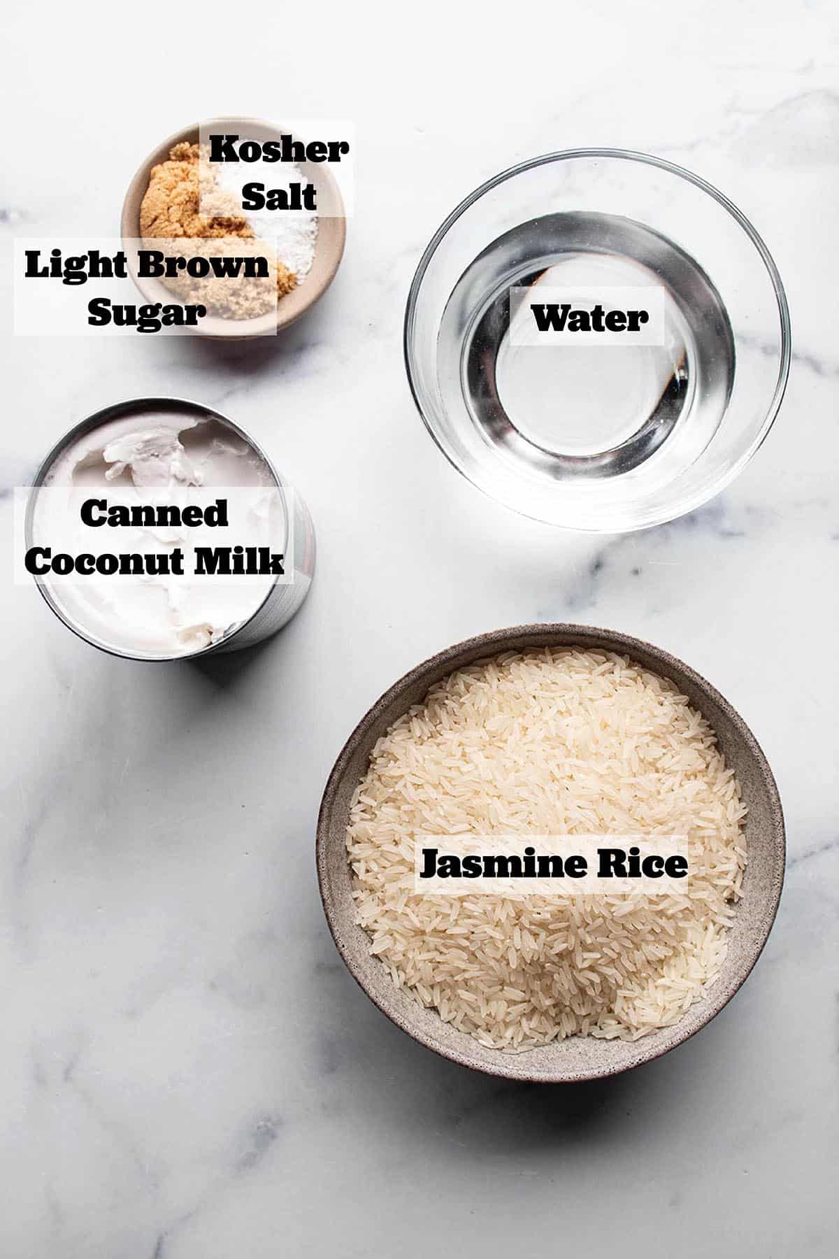 Ingredients to make coconut rice. A bowl of jasmine rice, water, coconut milk, brown sugar and salt.