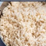 A pot full of rice with words that say quick and easy coconut rice.