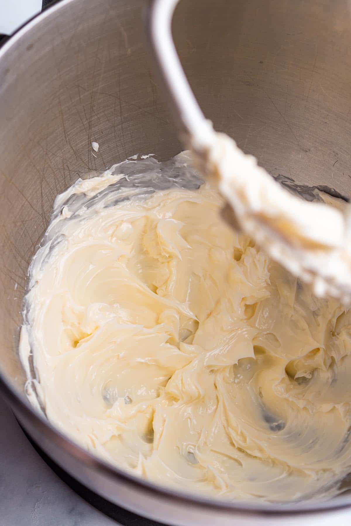 A stand mixer with butter creamed.