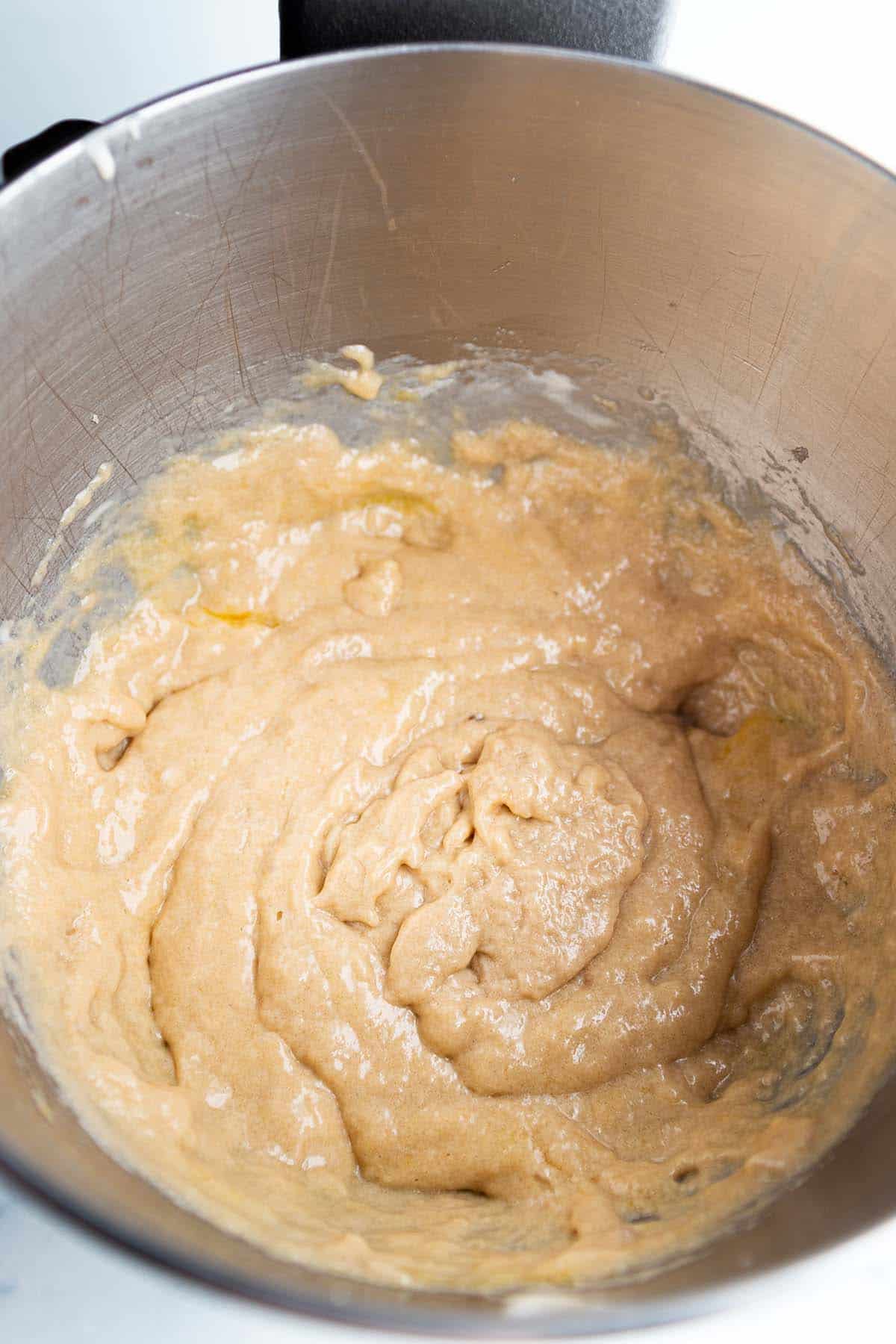 Cookie batter inside a bowl of a stand mixer.