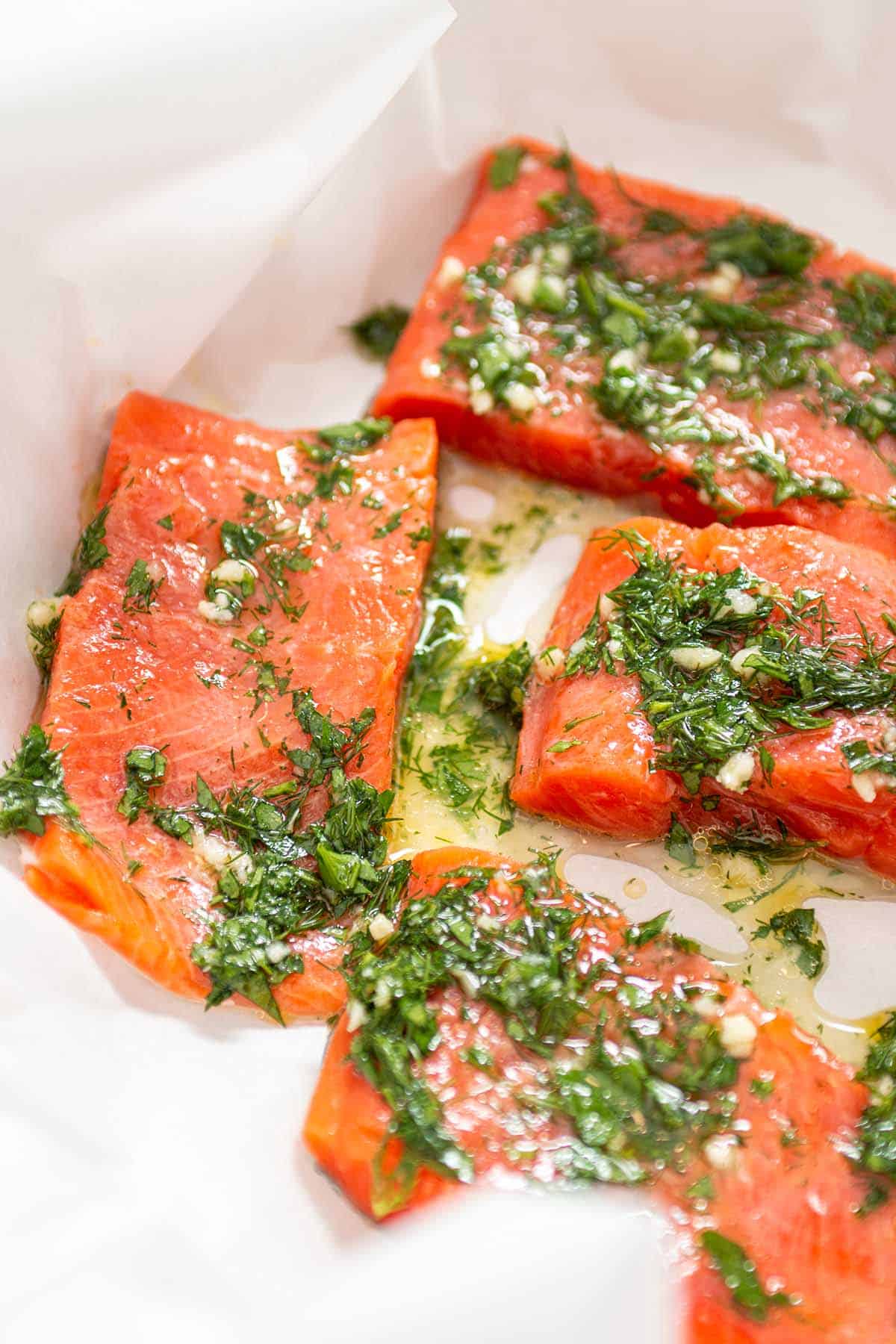 Chunks of salmon with herbs and olive oil.