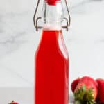 A flip lock bottle with text that says strawberry simple syrup.