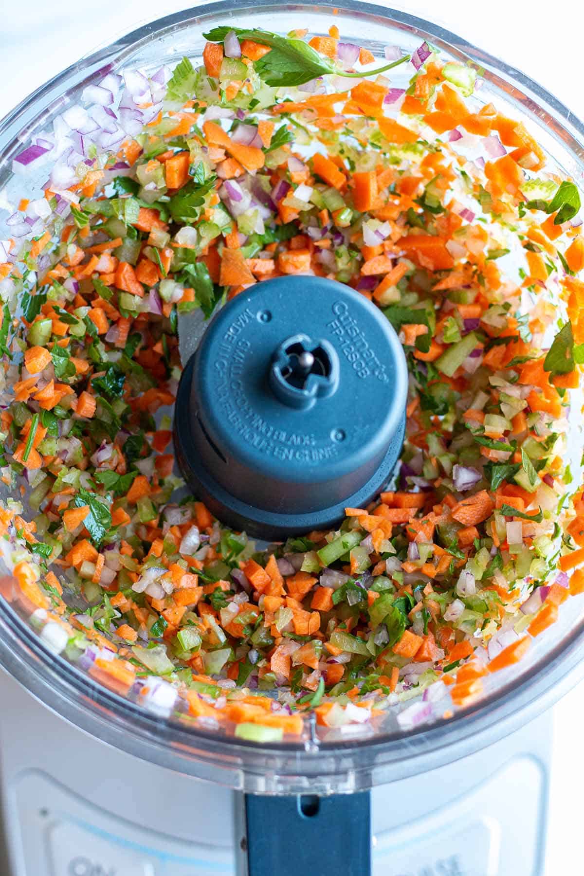 A food processor with finally diced veggies.