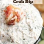 A bowl of crab dip with chunks of Dungeness crab on top.