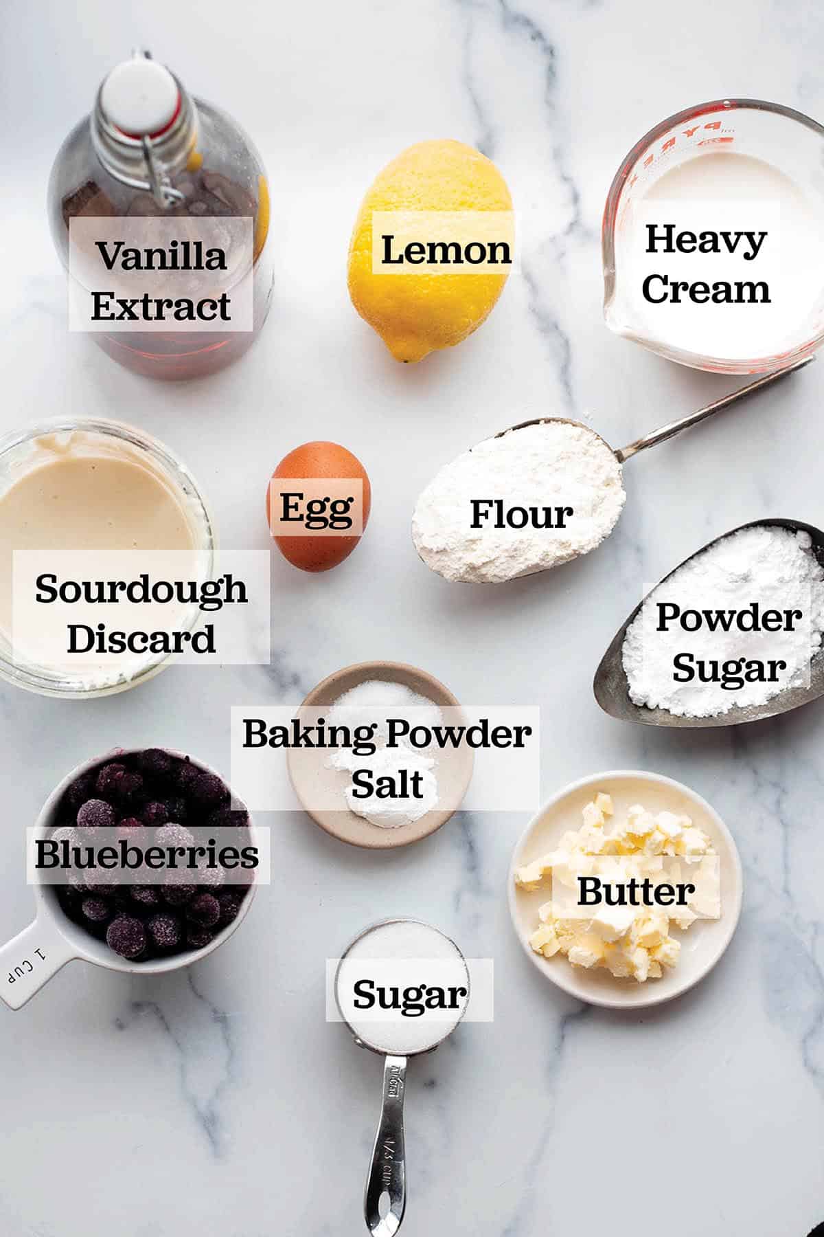 Ingredients in measuring cups and bowls to make blueberry scones.