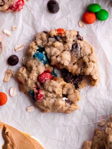 An oatmeal cookie with M&M's, chocolate chips, and peanut butter.