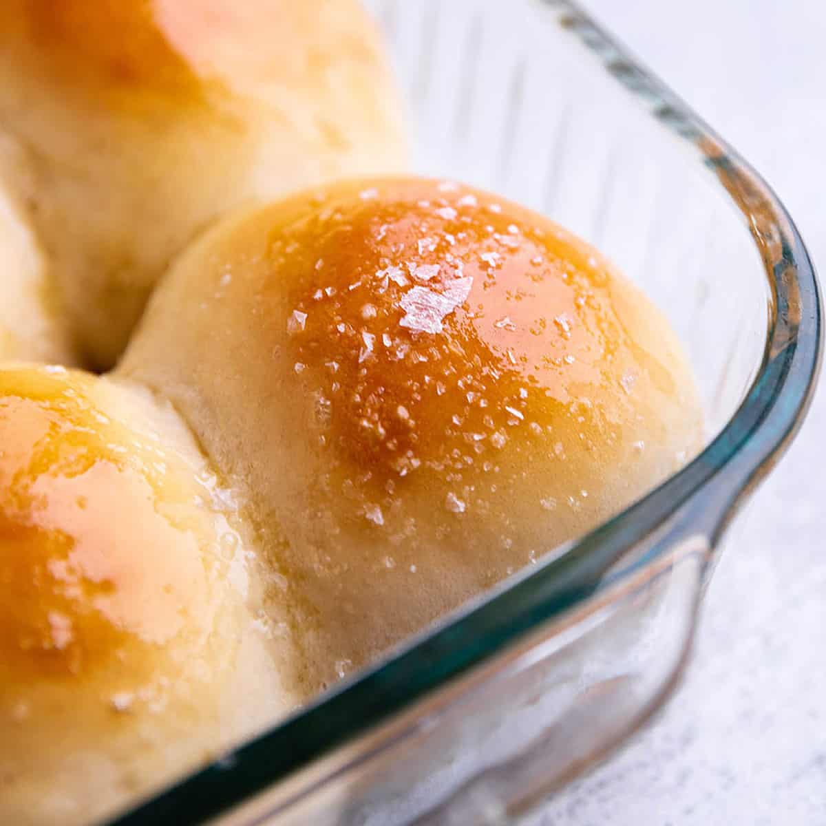 Homemade dinner roll in a glass pan with sea salt on top. 